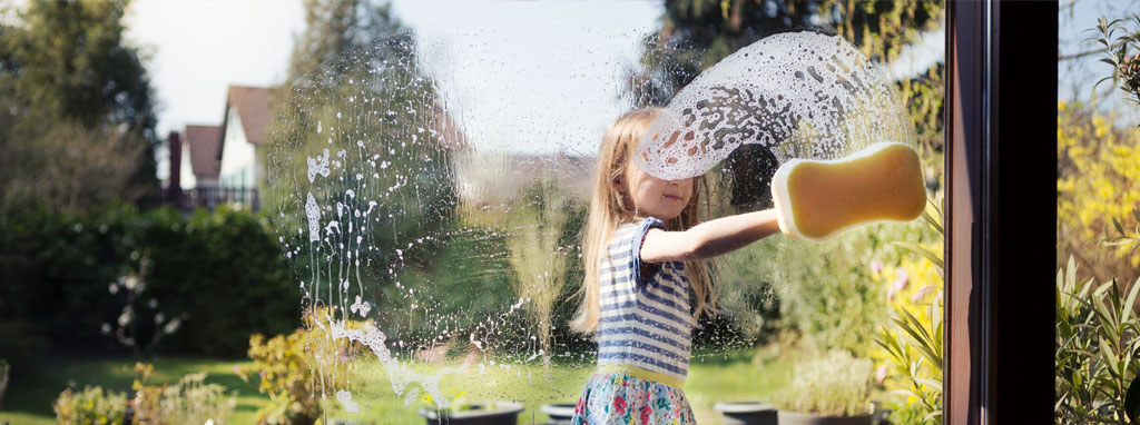 child cleaning window
