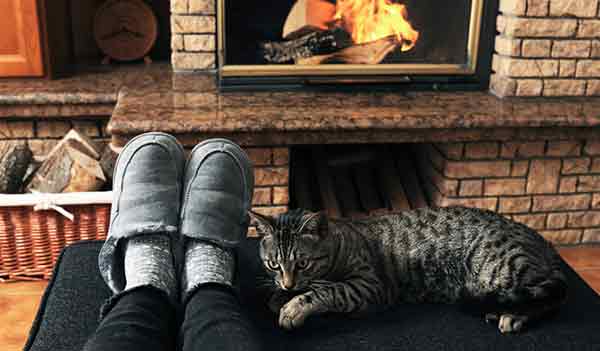 slippers and cat by fireplace