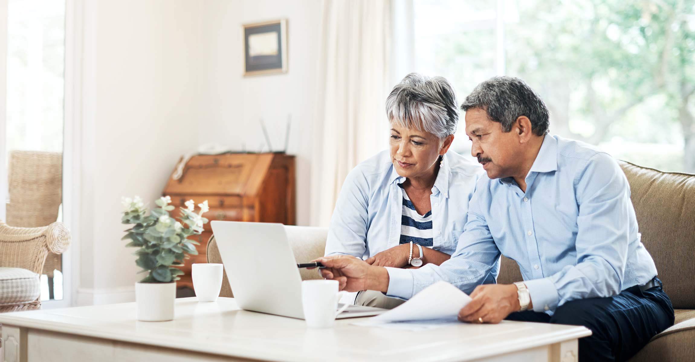 couple on sofa using laptop