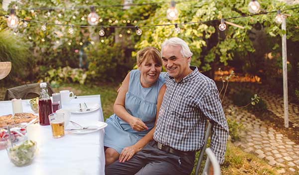 older couple at table in garden
