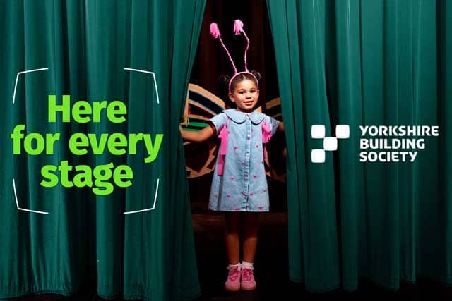 Girl peering through theatre curtains, with caption that says 'Here for every stage' and Yorkshire Building Society logo 
