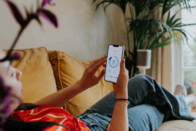 Woman managing heating on app 