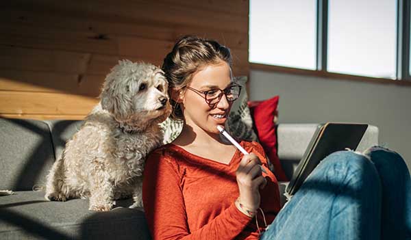 Woman looking at tablet with dog