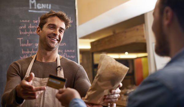 Man giving a bag to customer