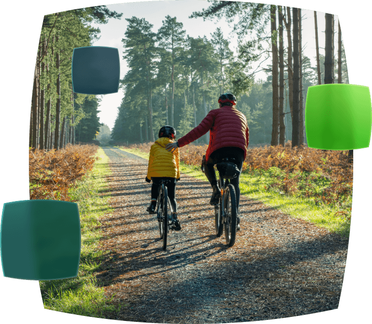 Father and child on an autumnal bike ride through a forest