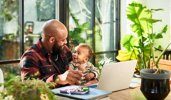 Man with laptop and child
