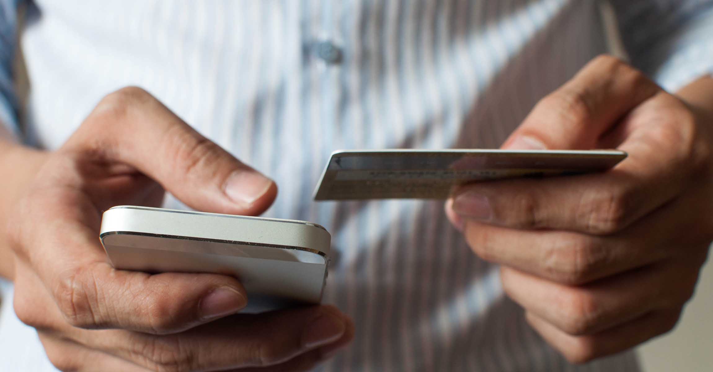 man using card to pay by phone