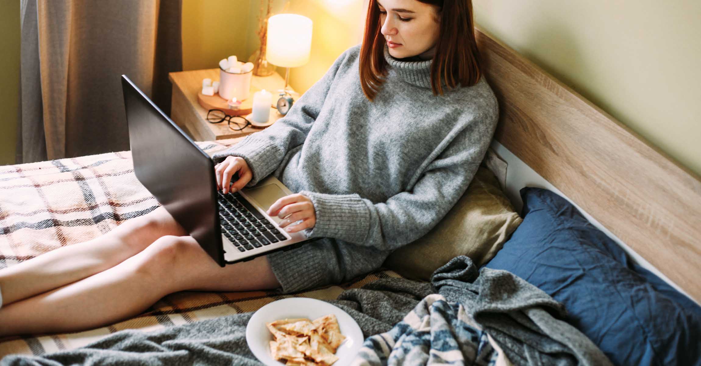 Woman with laptop and snacks