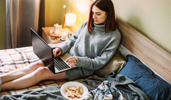 Woman with laptop and snacks