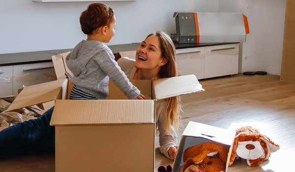 Boy playing in box with parent