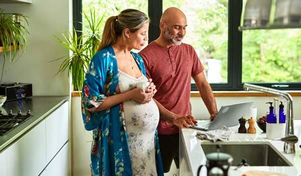 pregnant woman with partner in kitchen