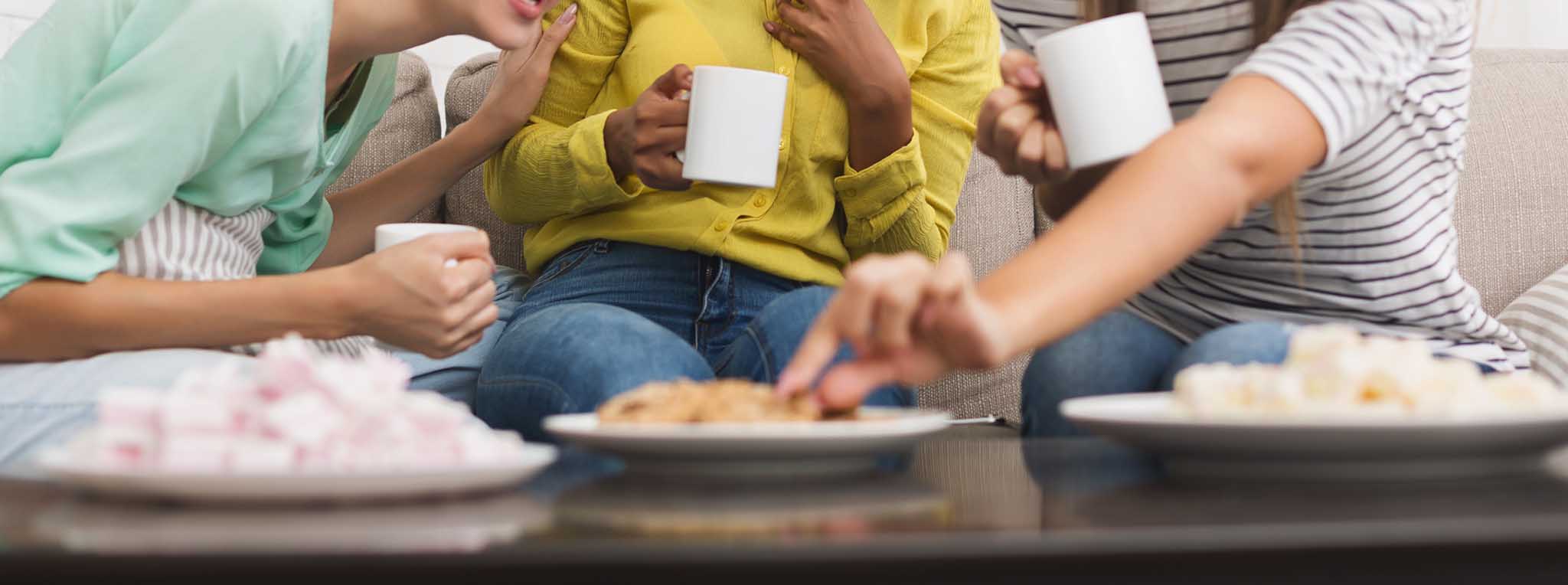 Women enjoying biscuits and cake