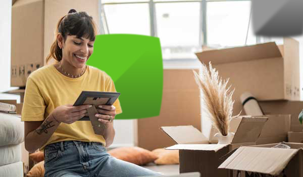 woman looking at picture whilst packing