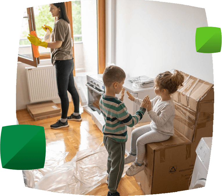 women cleaning whilst children play near moving boxesr