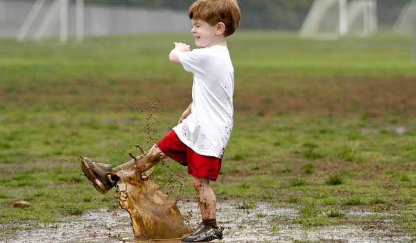 Child playing in puddle