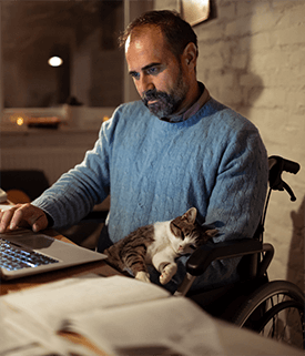 man in home office with cat