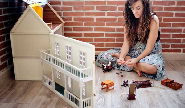 Woman and dolls house
