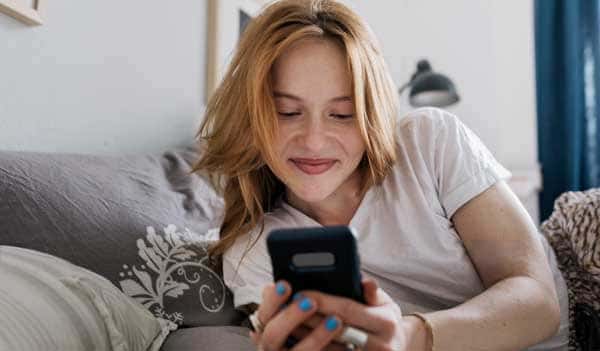 Woman smiling looking at phone