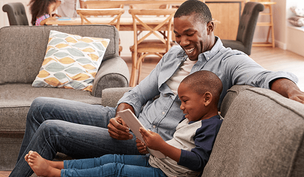 Father and son looking at tablet