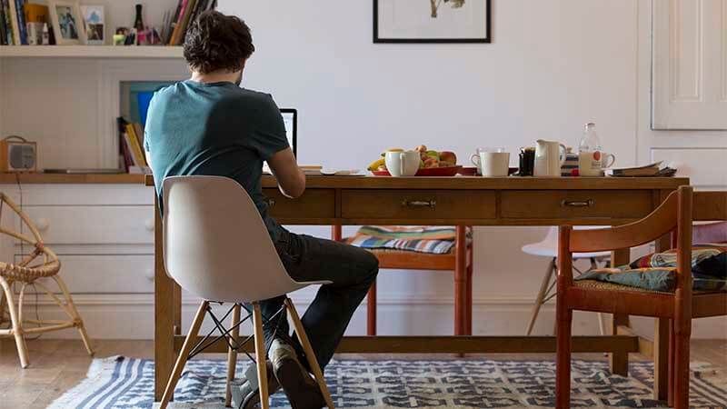 Man using laptop at table