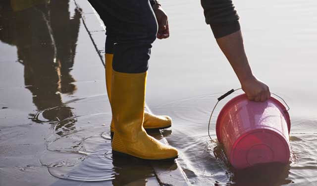 wellies and bucket in water