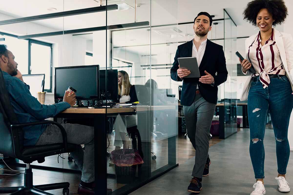 Man and woman walking through office