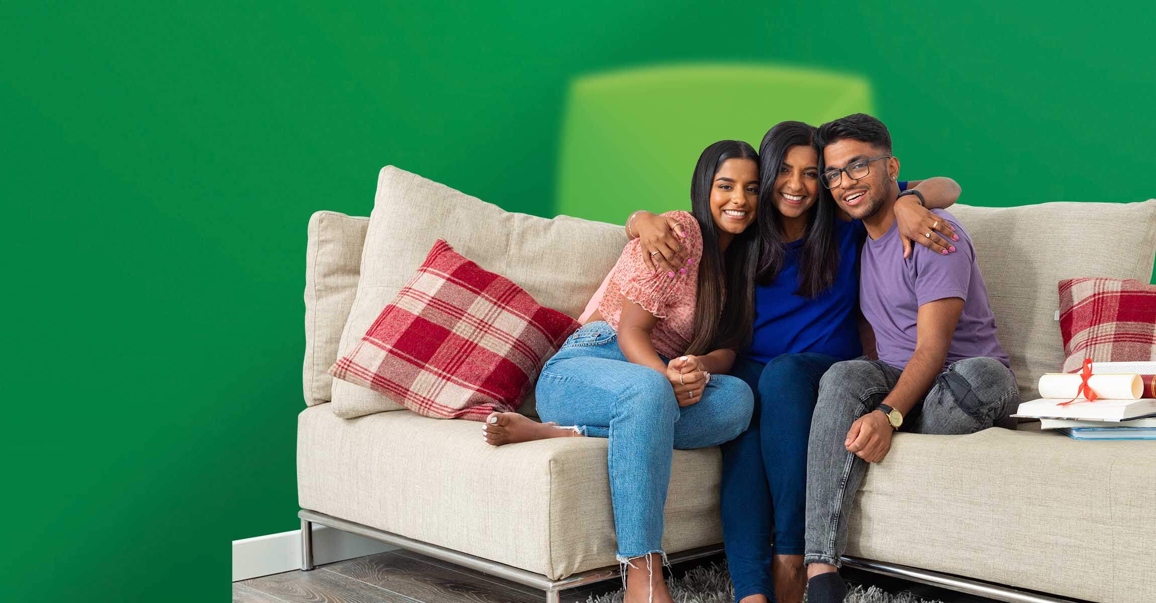 Mother with daughter and son smiling on sofa