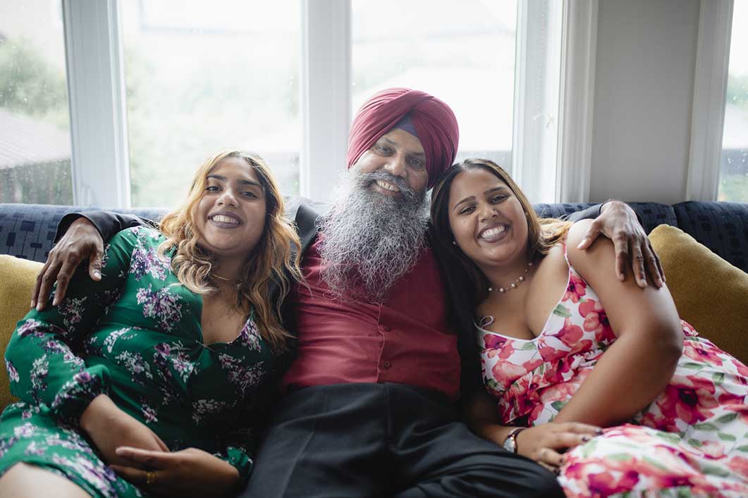 Family smiling on sofa