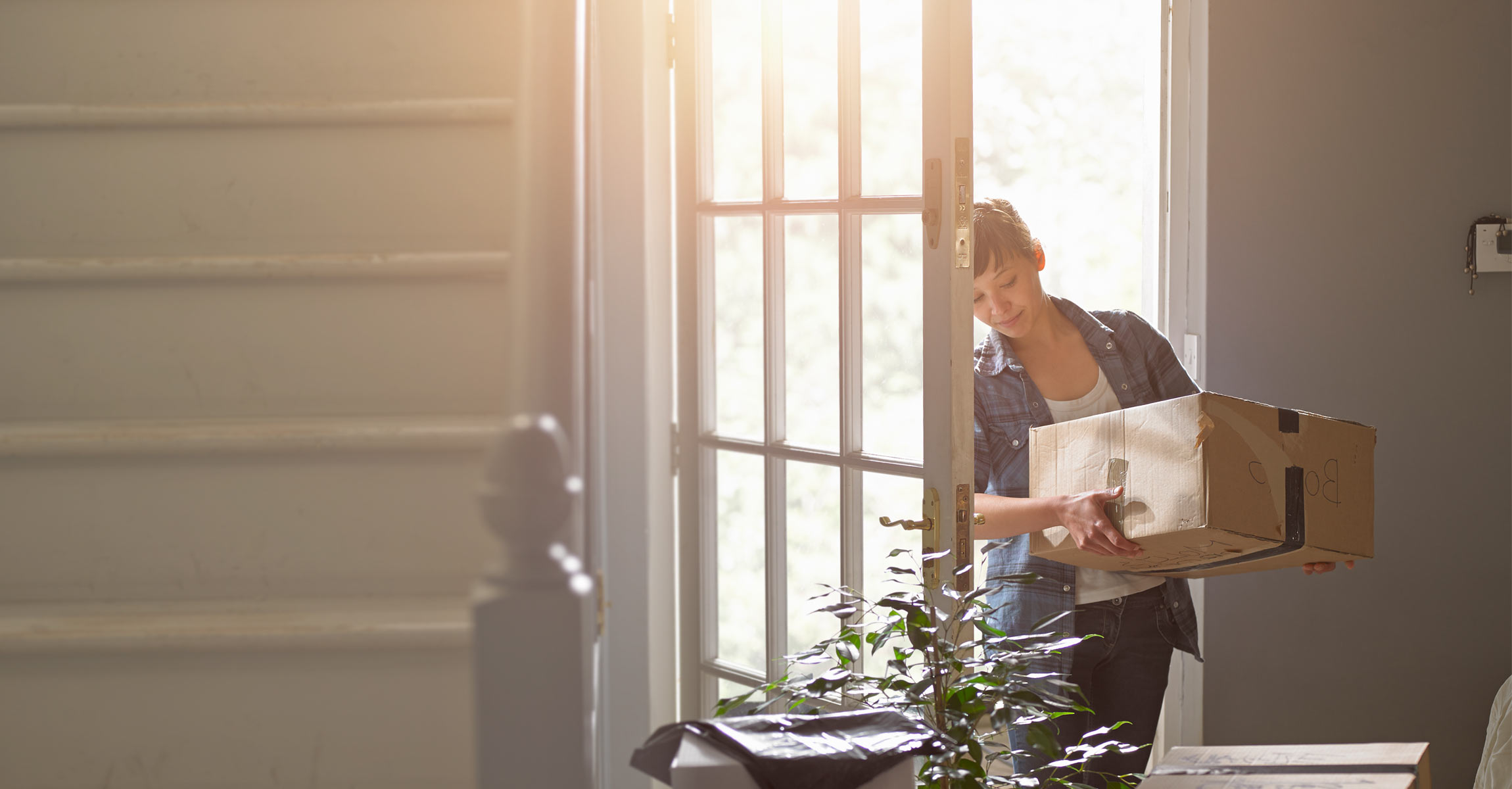 woman carrying moving box