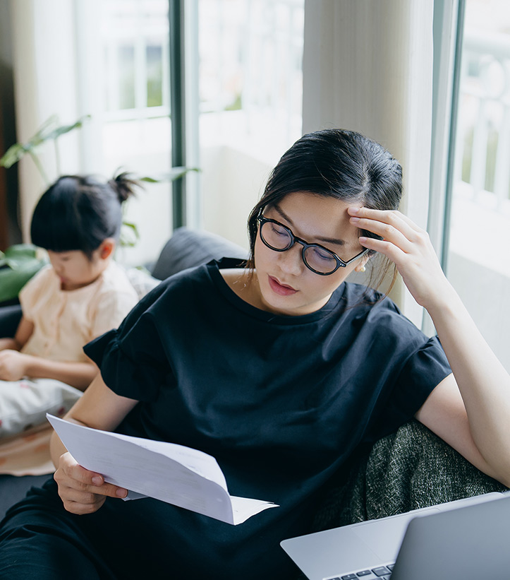 Worried woman looking at paper