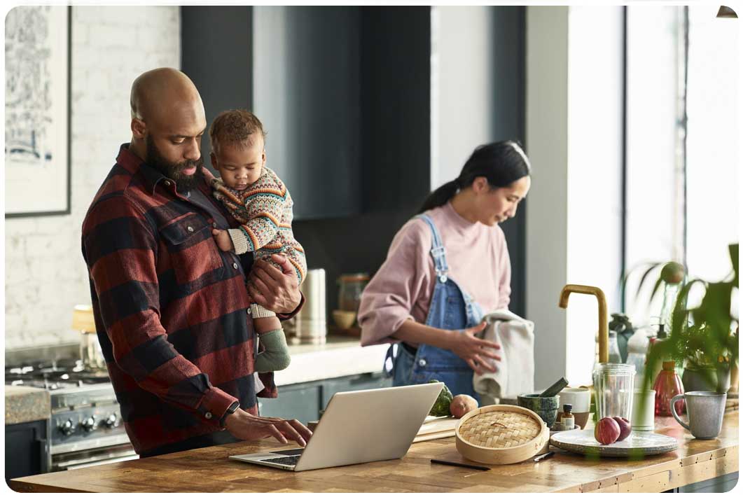 Family in kitchen with laptop