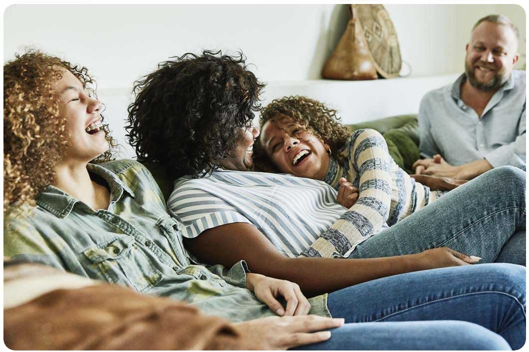 Family on sofa laughing
