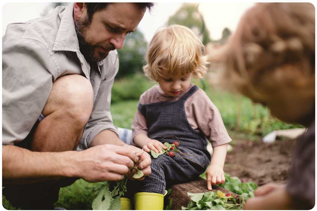 Father gardening with kids