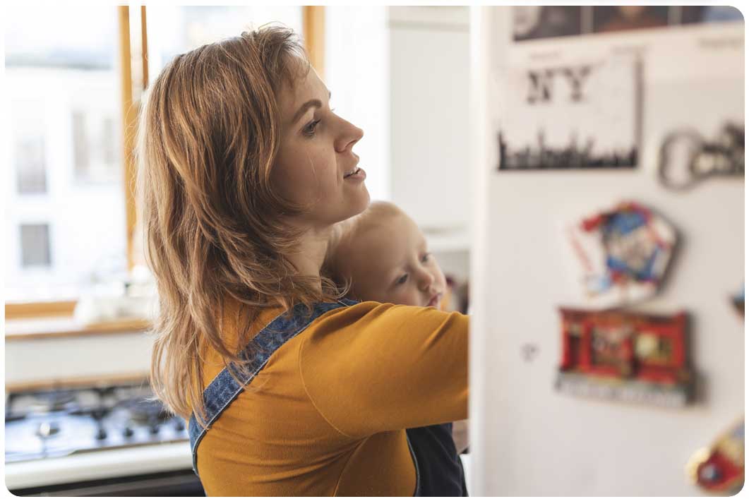 Woman and baby looking in fridge