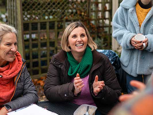 Smiling woman outdoors with friends