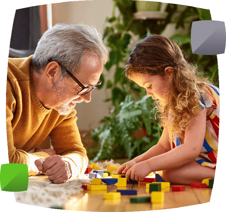 Grandfather and grandaughter playing with blocks