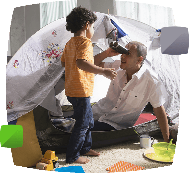 Man and boy in tent in living room