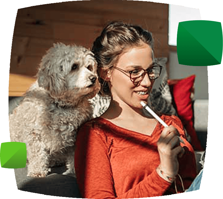 Woman in glasses and her dog looking at an iPad