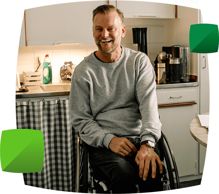 Man in kitchen looking happy